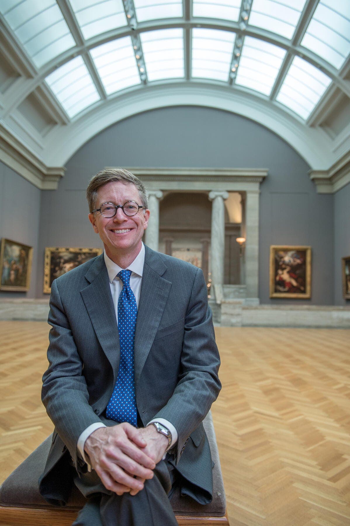 a man in a suit smiling