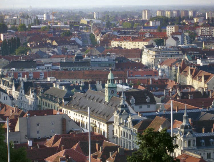 View of the city of Graz. The armory is marked by the greenish clock tower in the foreground.