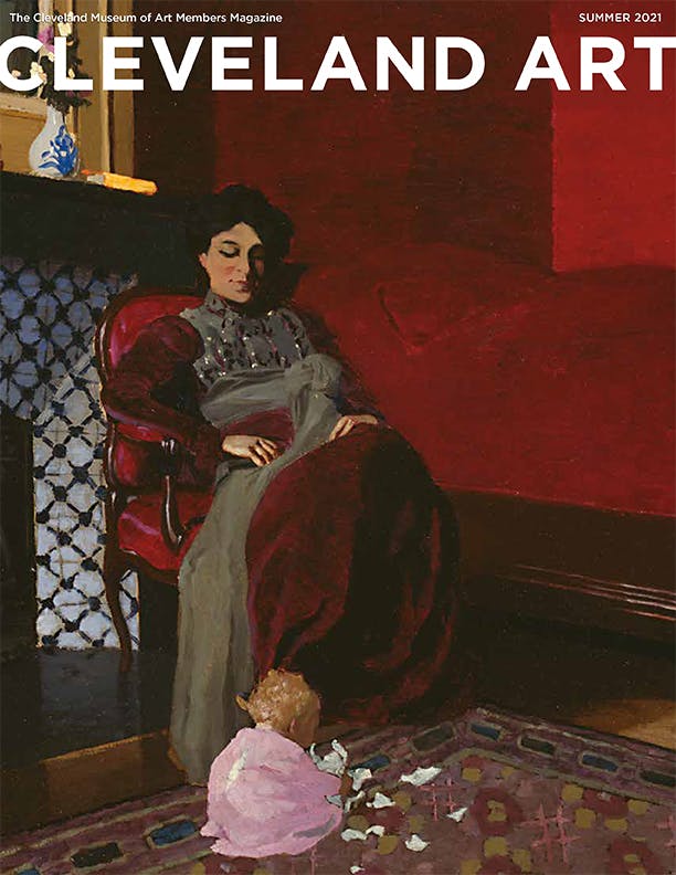 Magazine cover with a wealthy woman in a red dress in a chair looking down upon a baby in pink, in front of a blue and white tile fireplace in a red room
