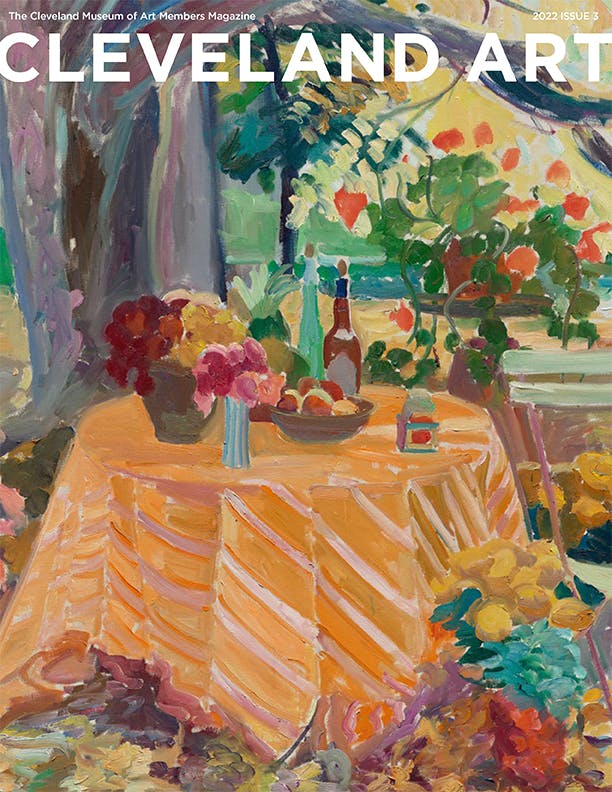 Magaziner cover with painting of a colorful picnic on an orange tablecloth