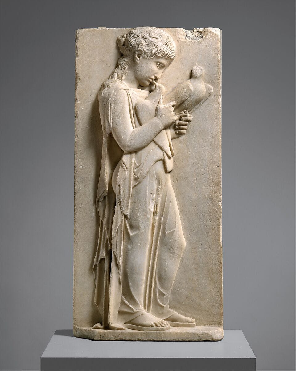 Marble grave stele of a little girl holding two doves