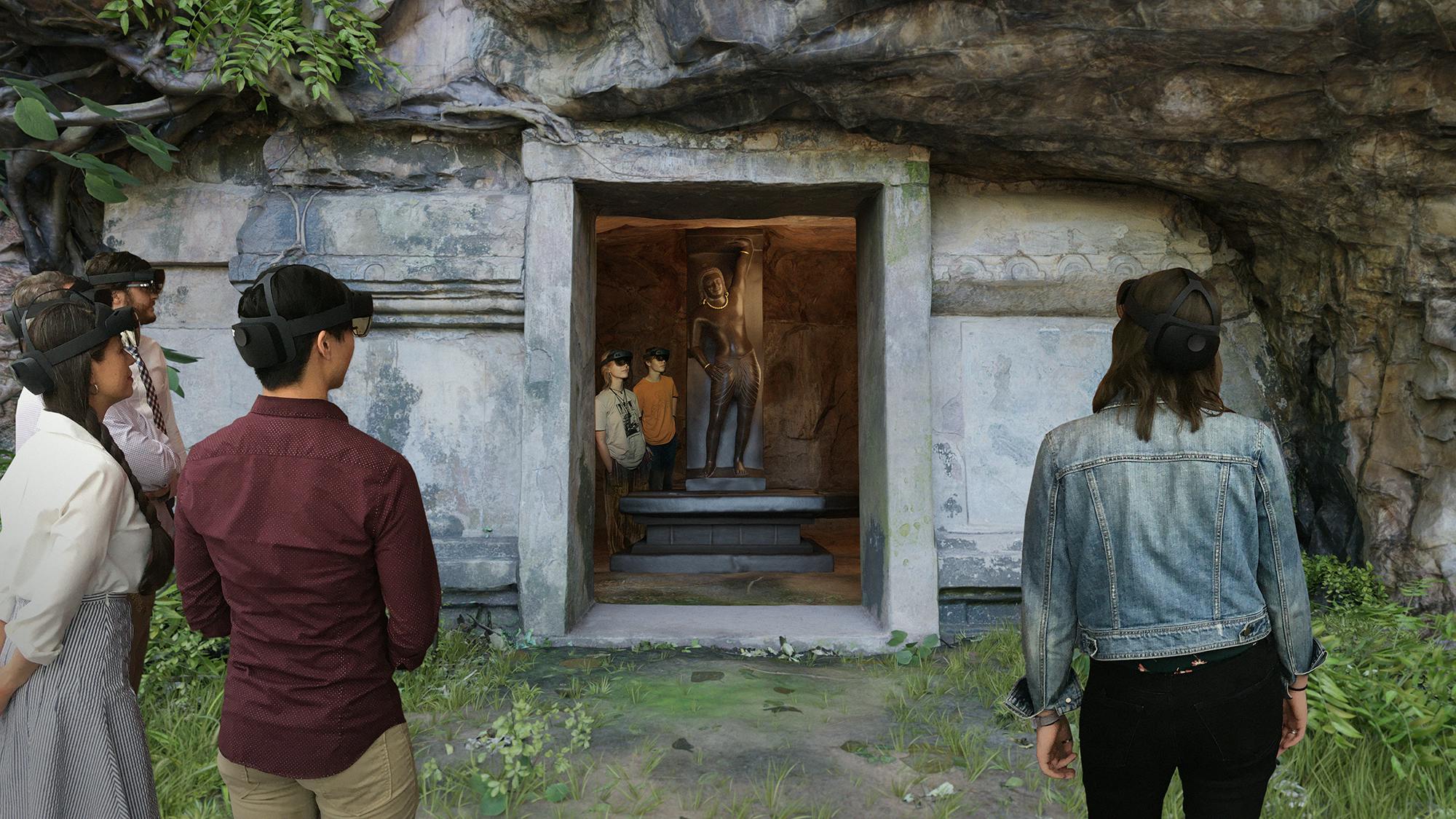 Group of people standing around a hologram of a stone doorway