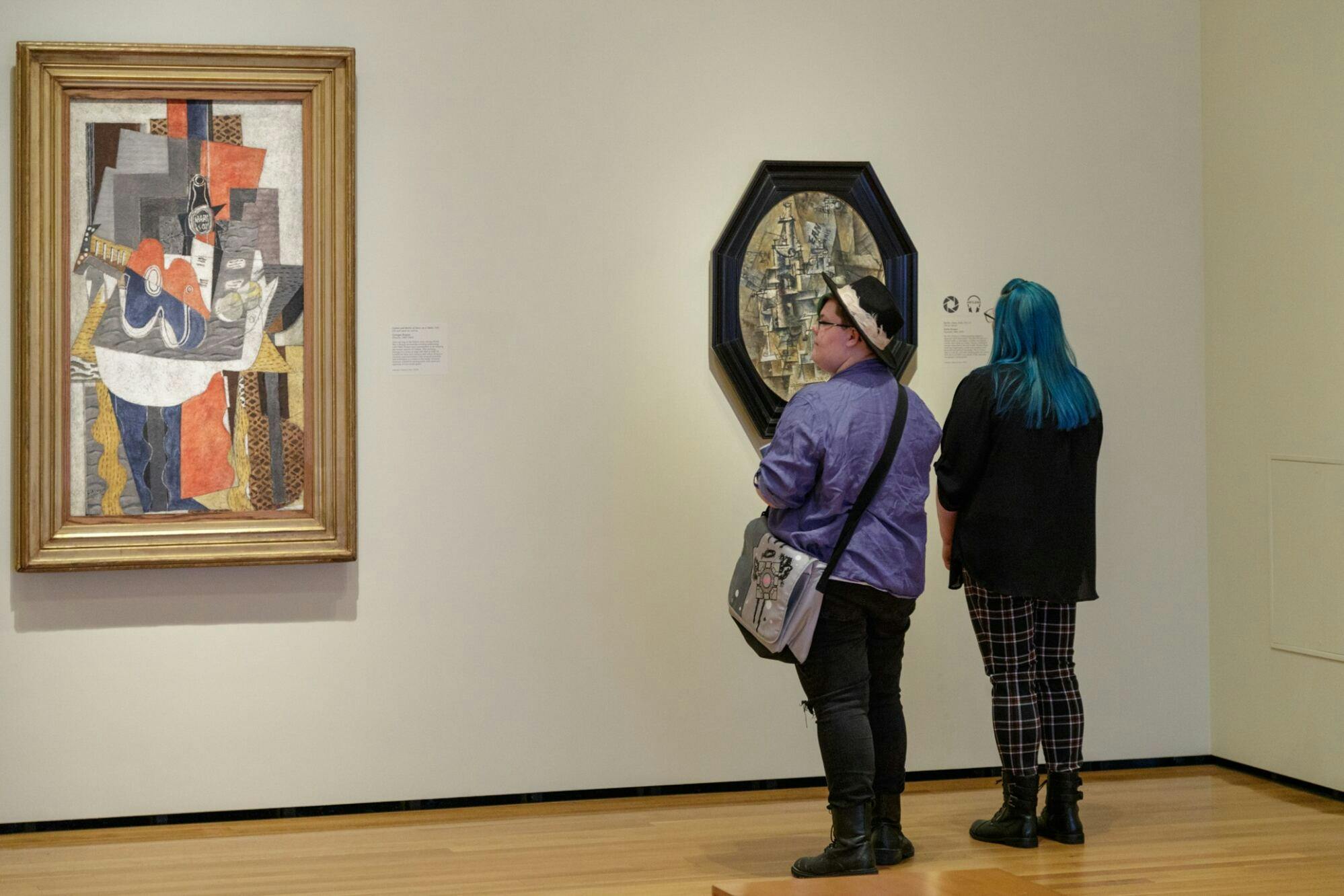 Two visitors admiring art in the CMA