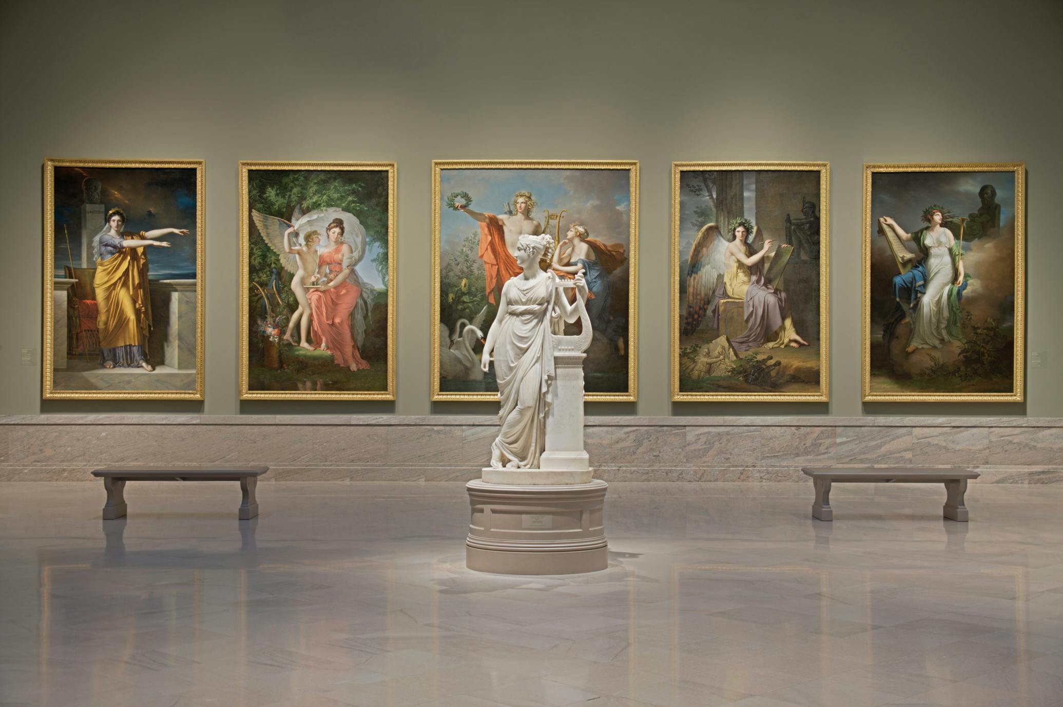 Sculpture in front of five paintings in a gallery at the museum