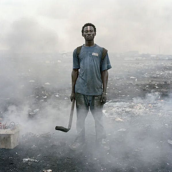 Man with hockey stick surround by ash and smoke