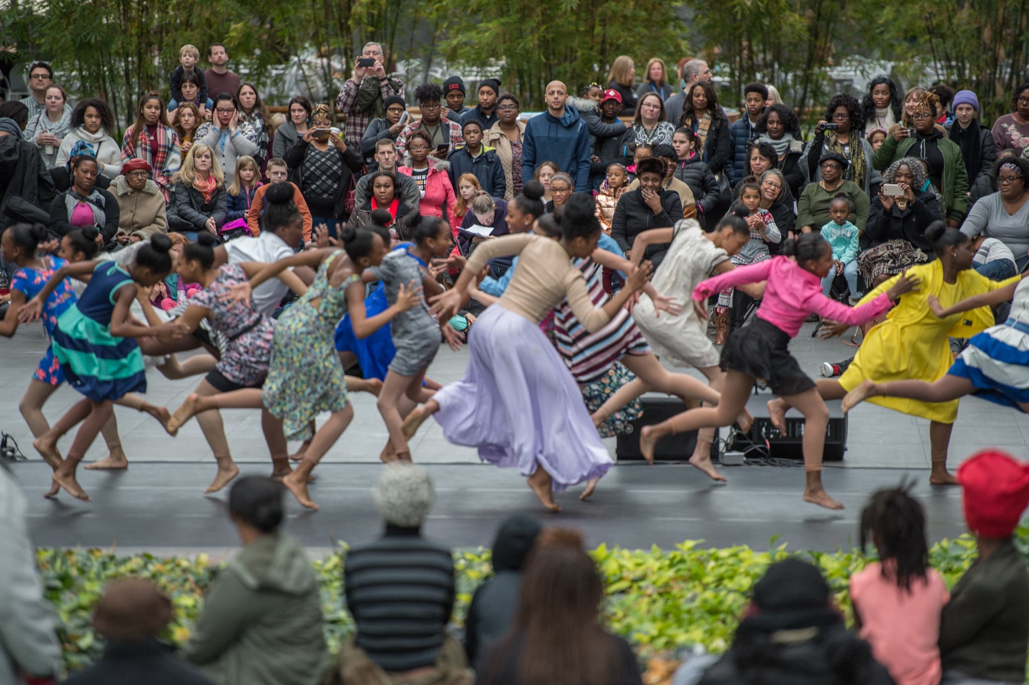 crowded room full of people dancing surrounded by an audience