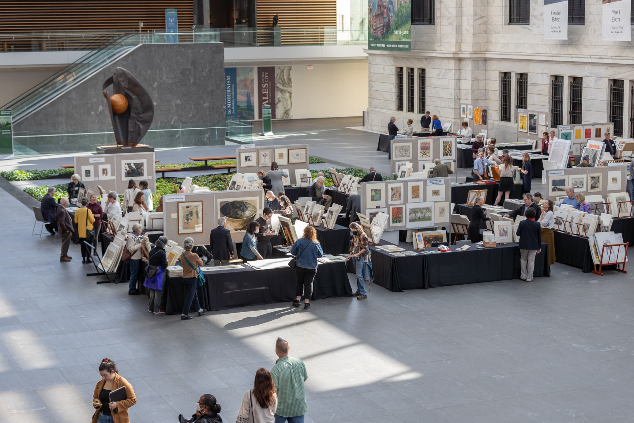 Visitors exploring prints in the museum