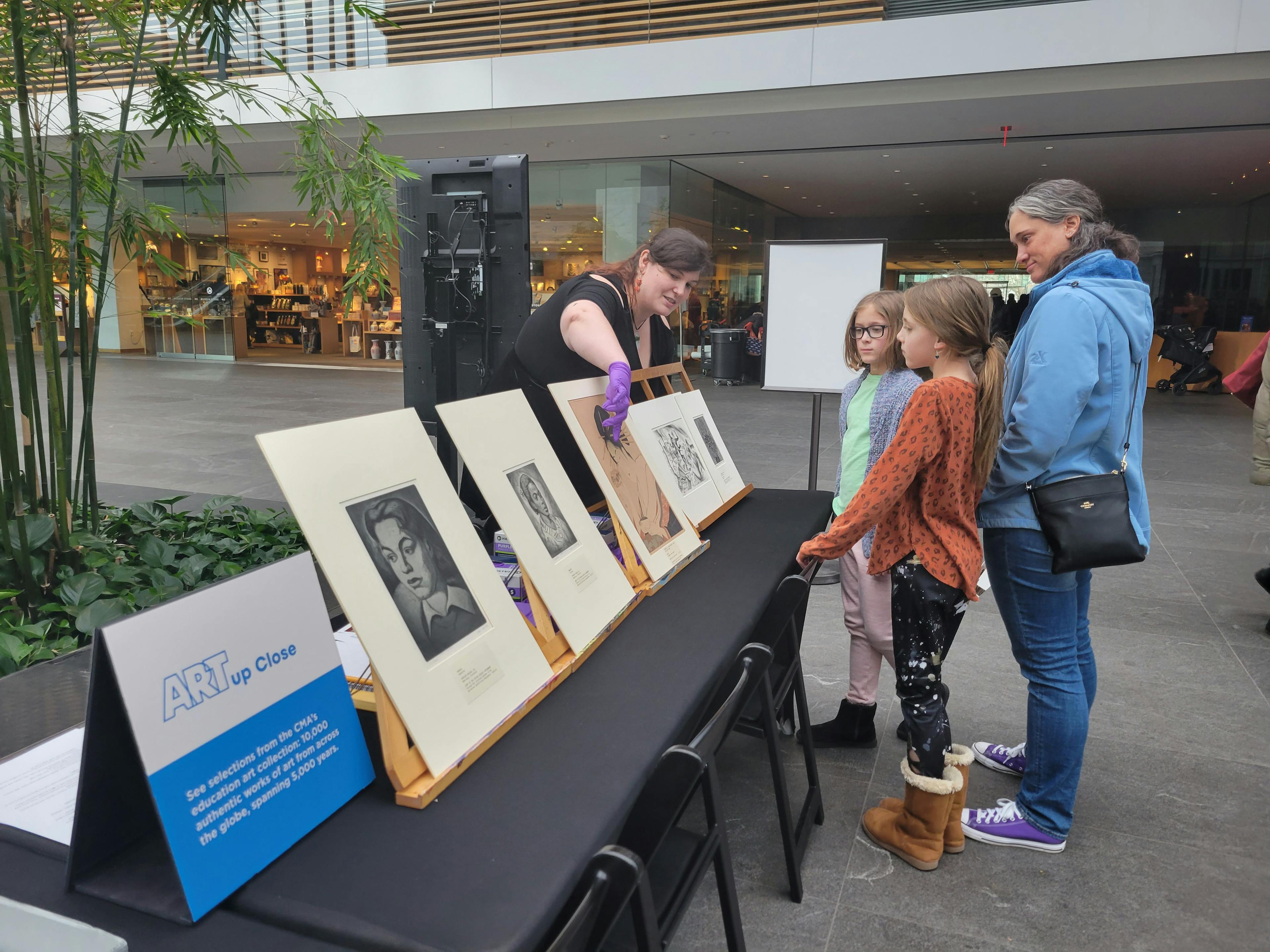 a family looking at prints on display