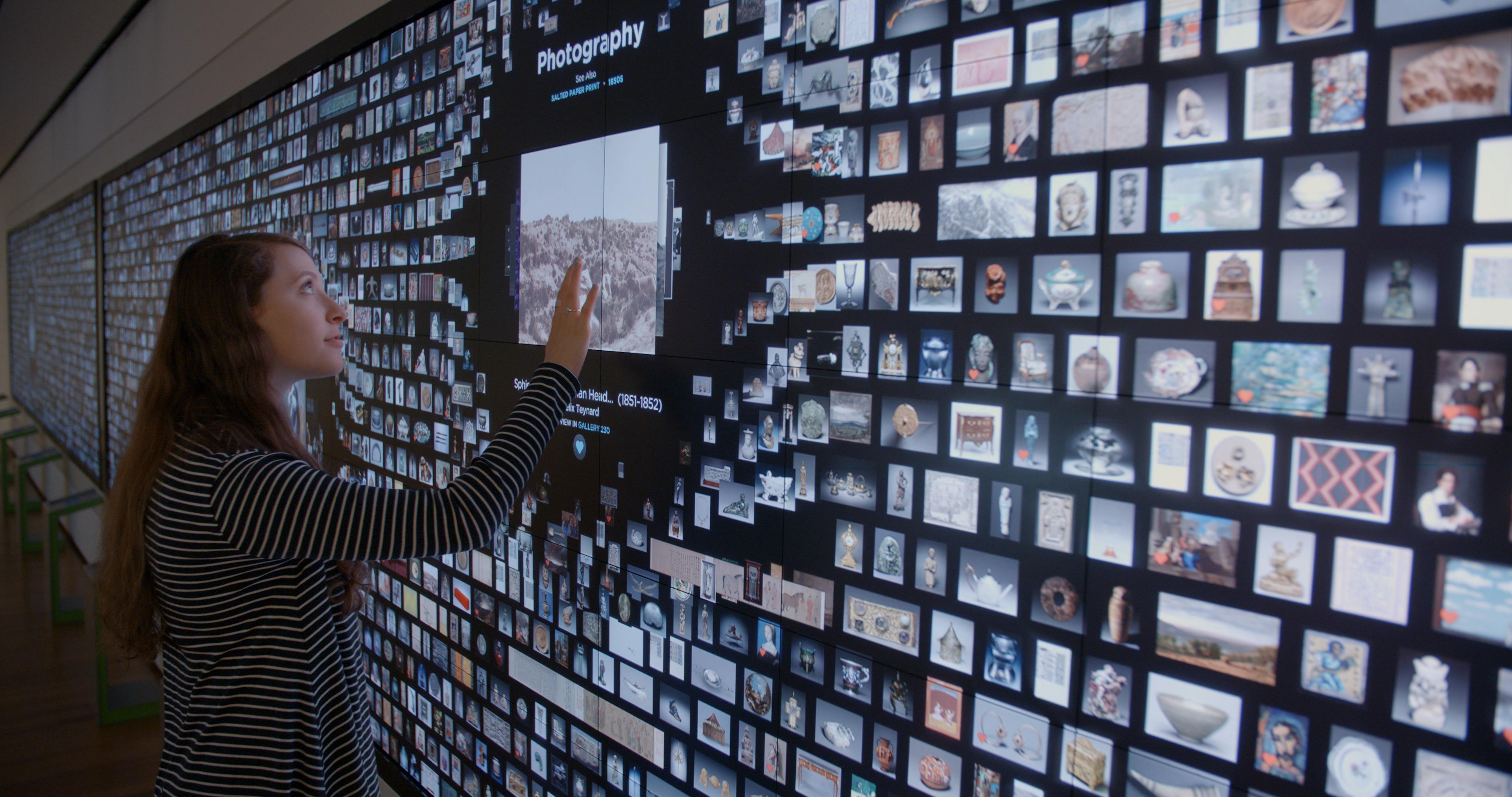 A visitor interacting with the ArtLens Wall
