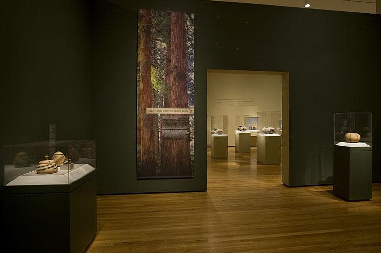 gallery with art hanging from the ceiling