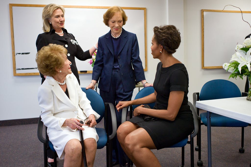 Four American First Ladies talk together in a group