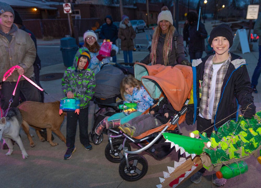 Family participating in the Towpath Trail Lantern Parade with upcycled lanterns.