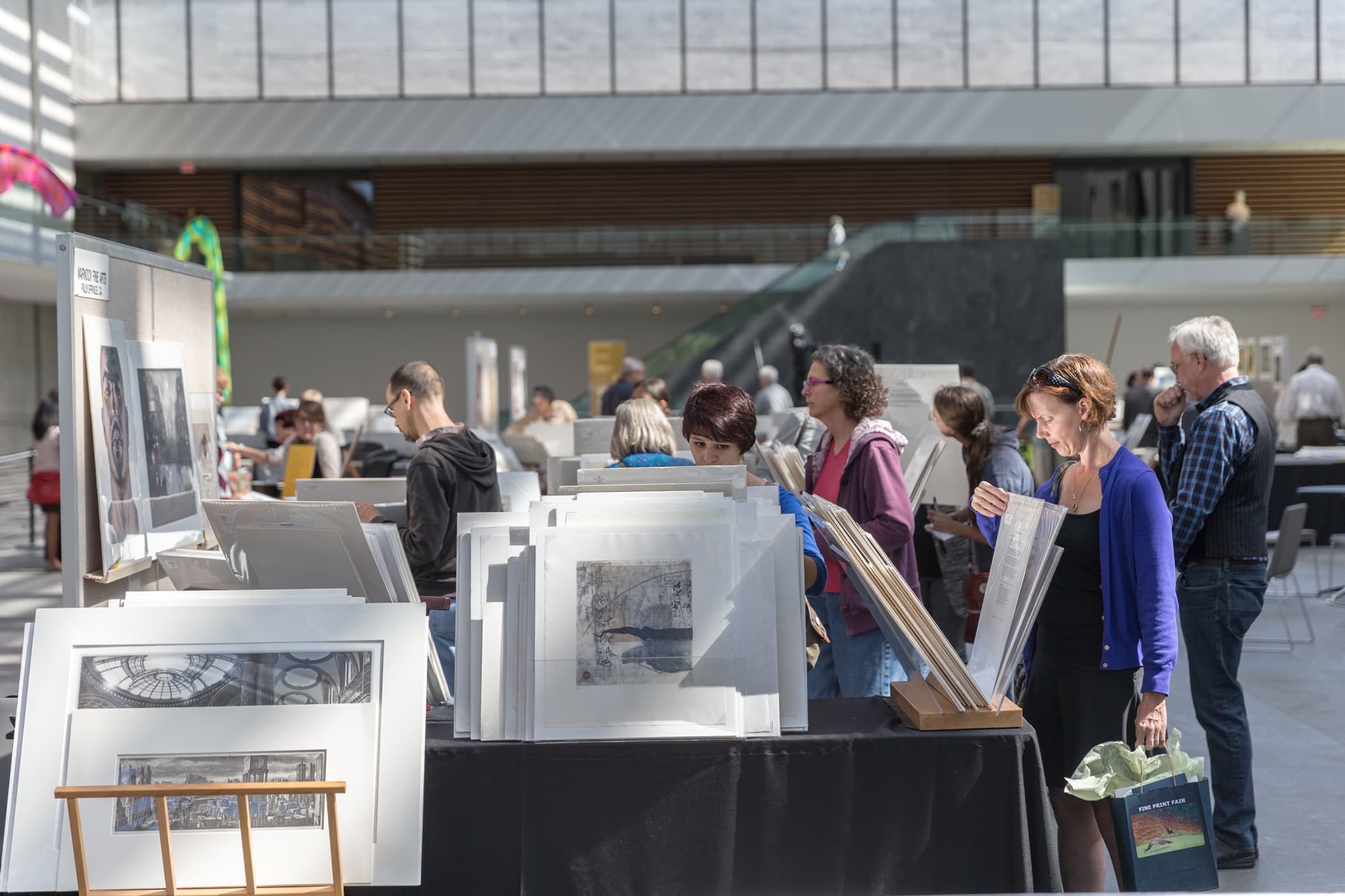 People browsing through art prints