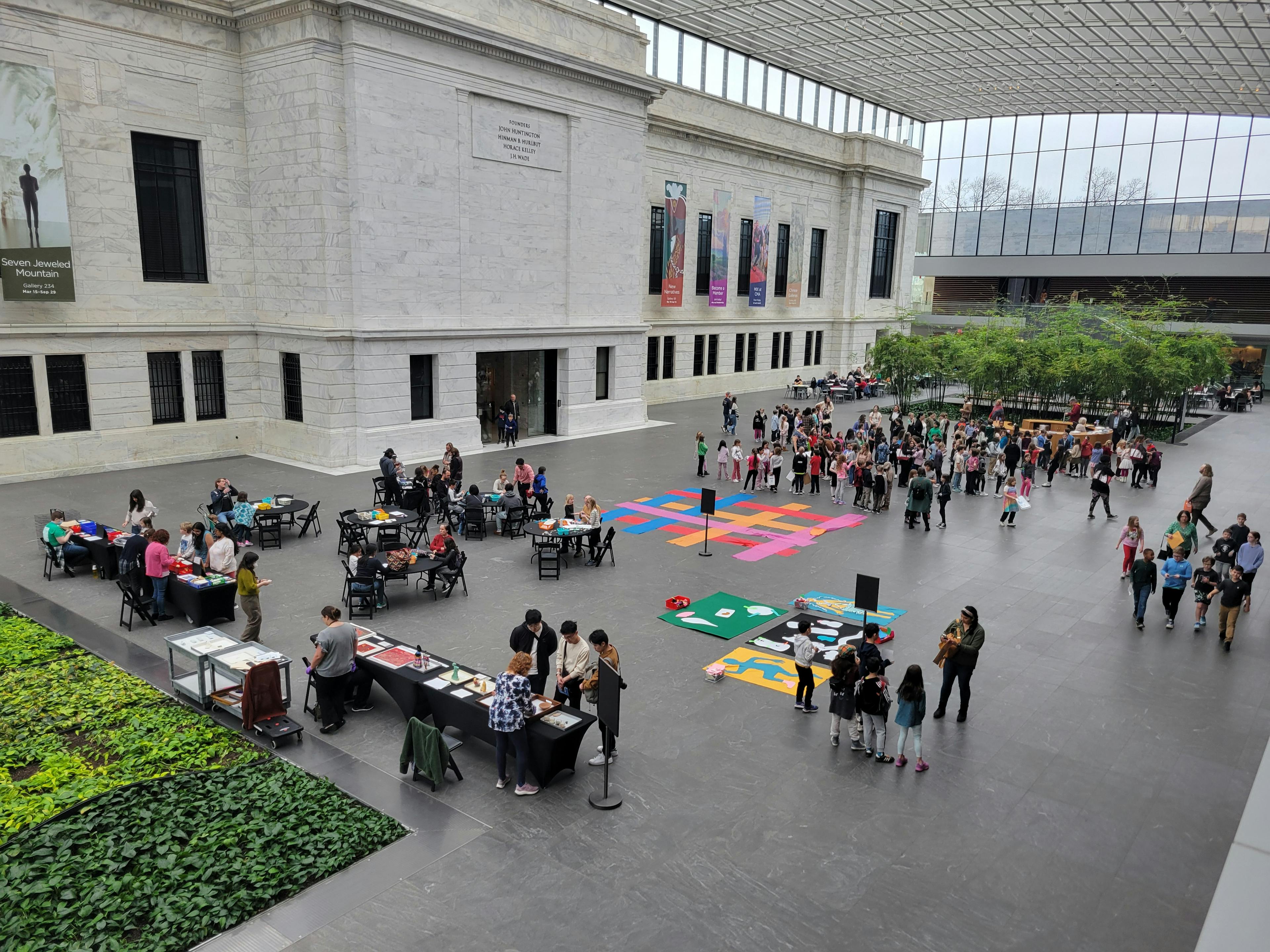 Students and families gather in the museum atrium
