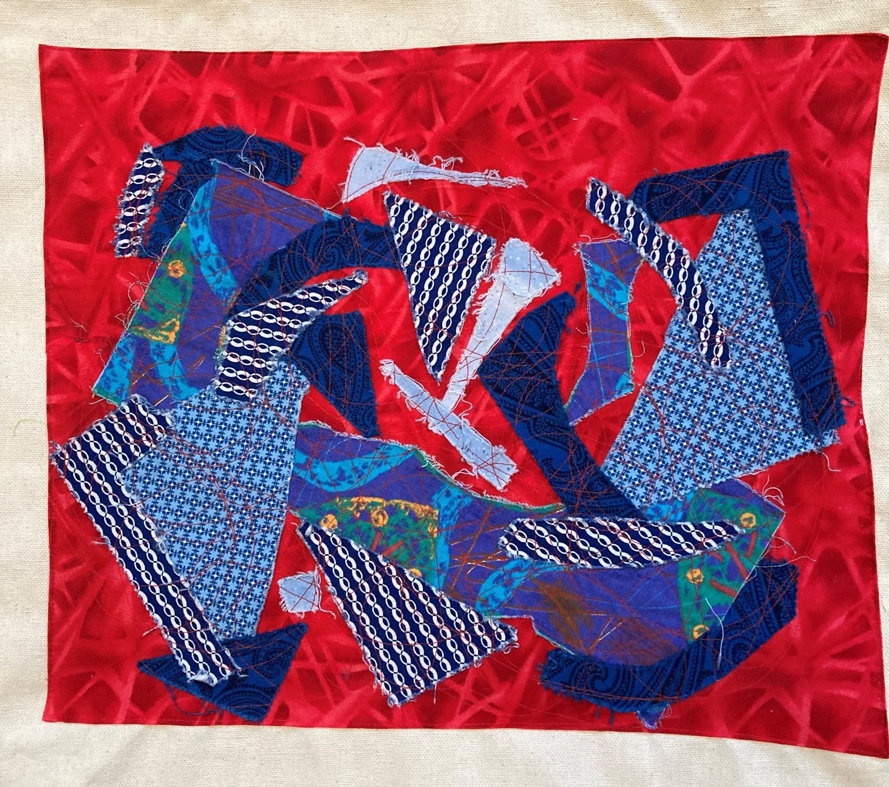Image of collaged fabric of different colors and different dynamic shapes.
