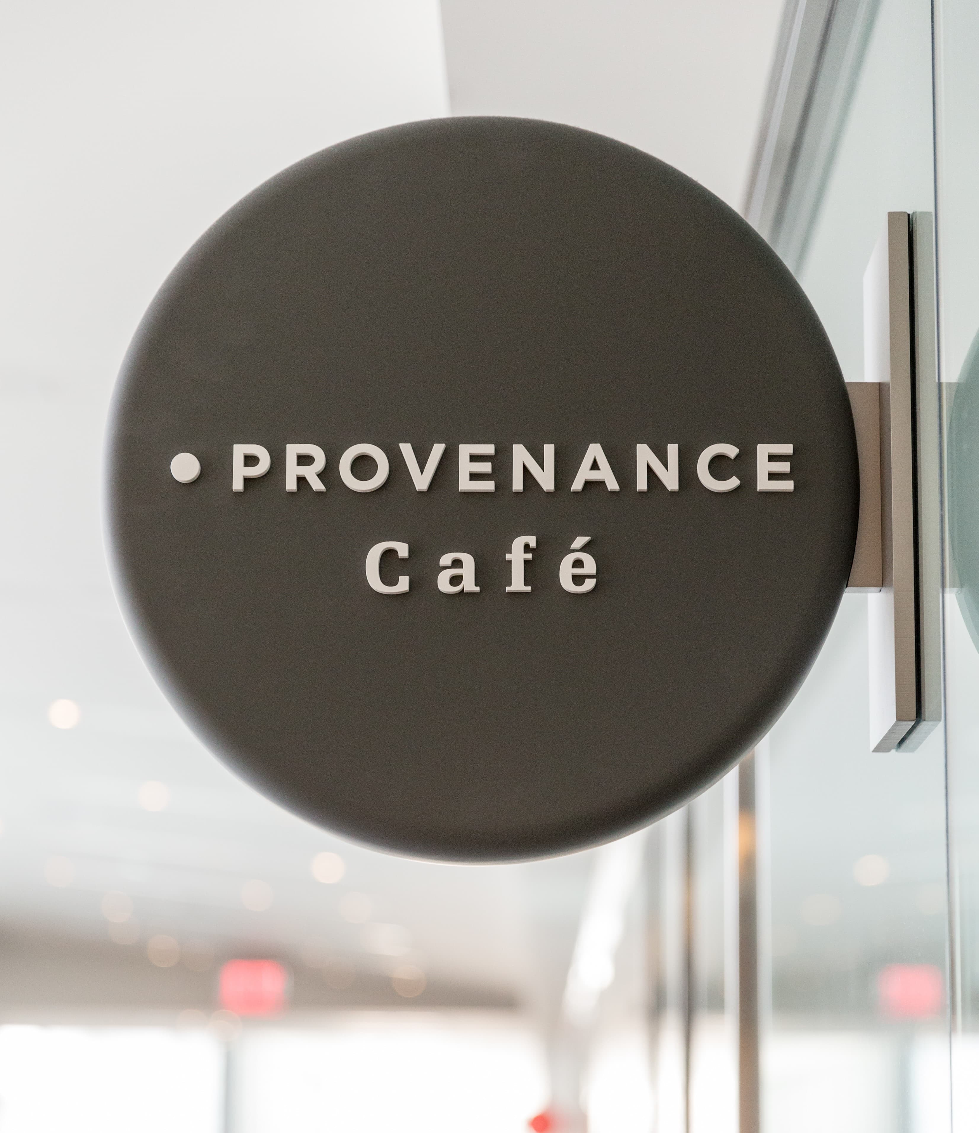 A black circle sign reading "Provenance Cafe" in white font.