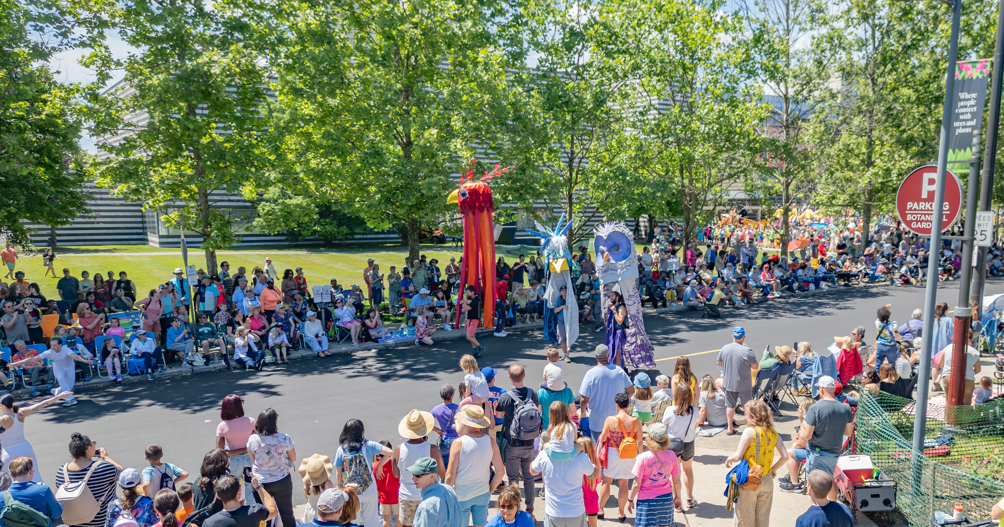 Street parade of life-size puppets and people looking onward