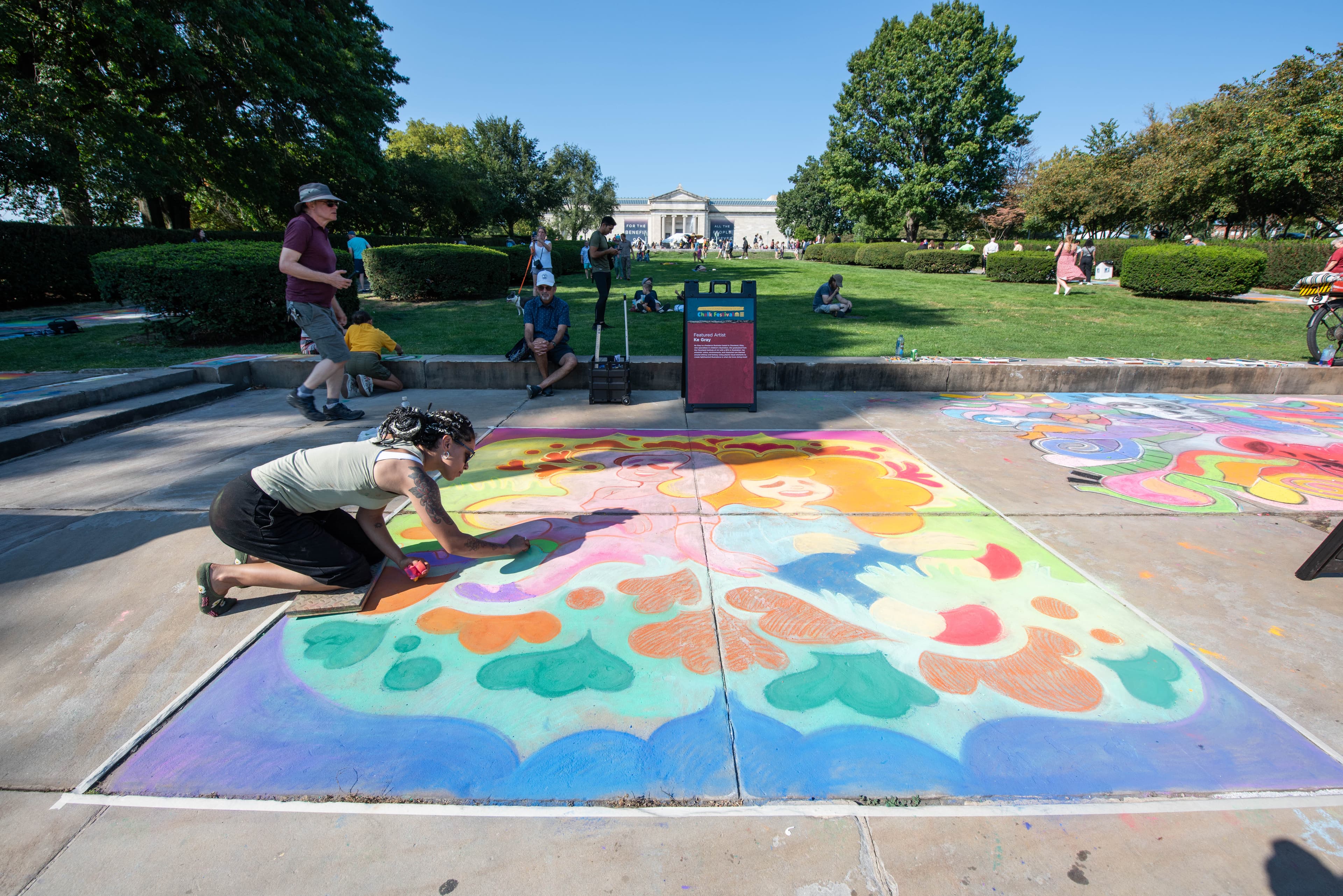 Person drawing with chalk on the sidewalk