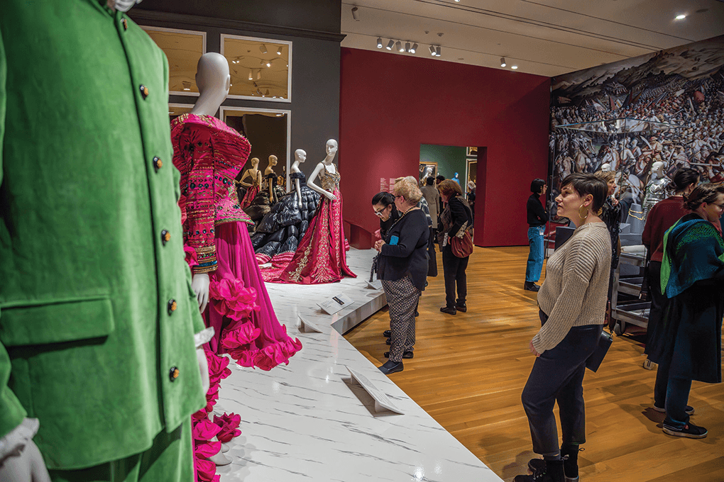people looking at fashion exhibit