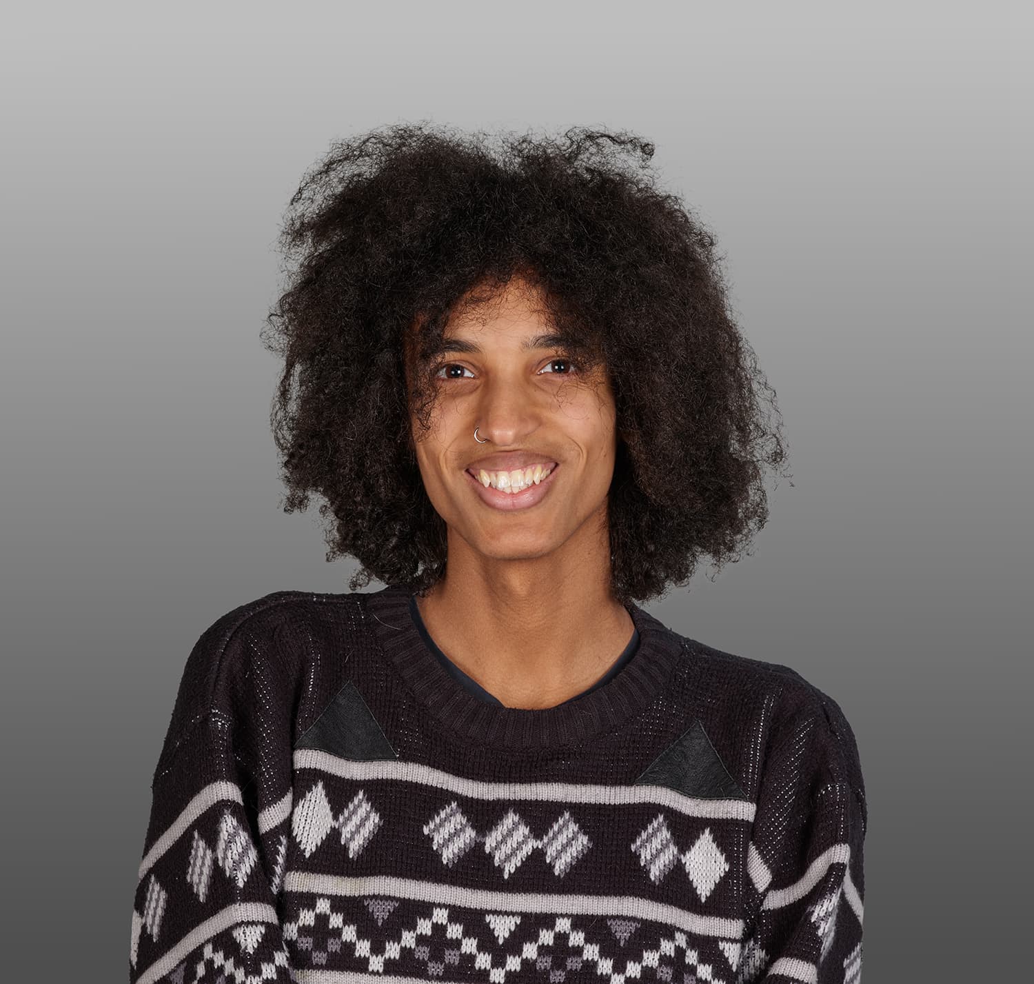Portait of a young man with a black and white geometric sweater