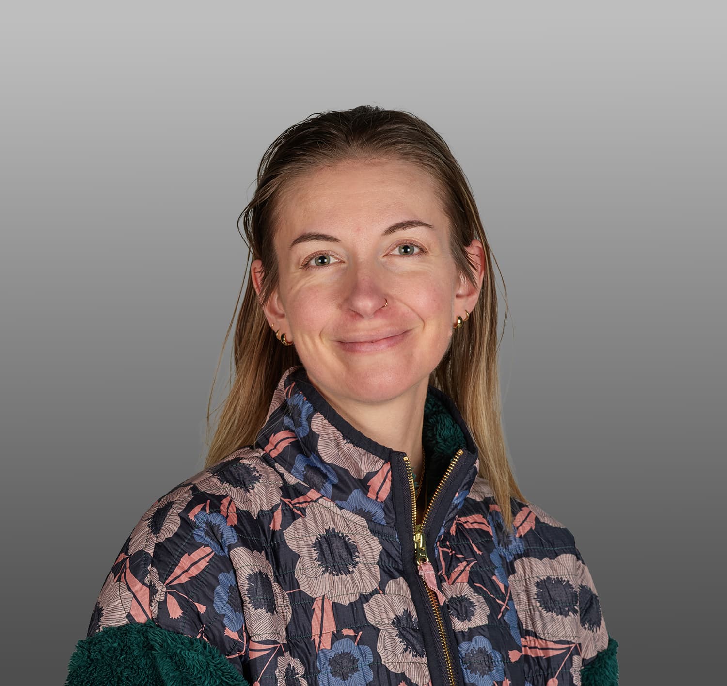 Headshot image of a woman with a floral jacket
