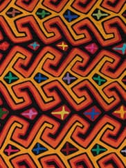 A patterned textile features primarily orange and yellow organic and geometric shapes with touches of green, purple, and blue.