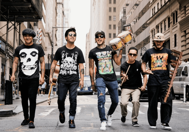 group of men with instruments walking down street