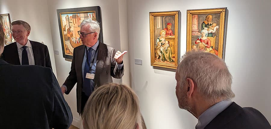 Men in suits on a tour stop in a museum gallery