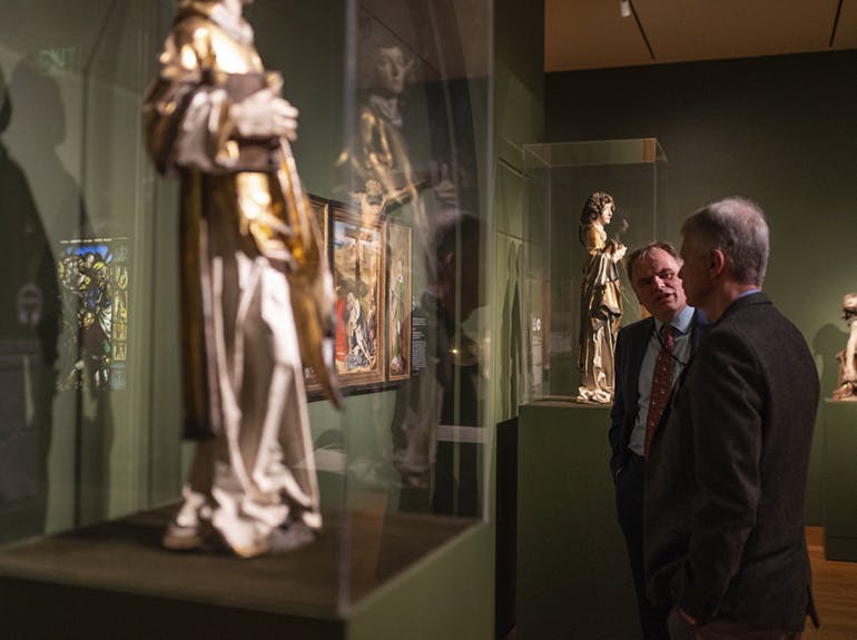 Two men look at art in the medieval galleries