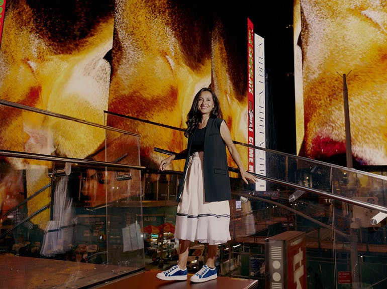 artist standing in front of her digital art