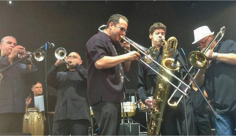 group of musicians performing with wind instruments