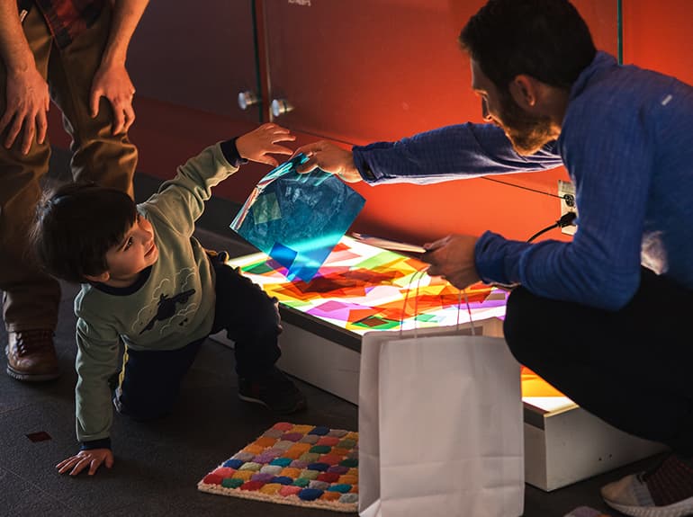 Child playing with cellophane on a lightbox